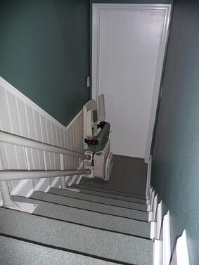 Parked and folded tight against the wall in a tight stairway